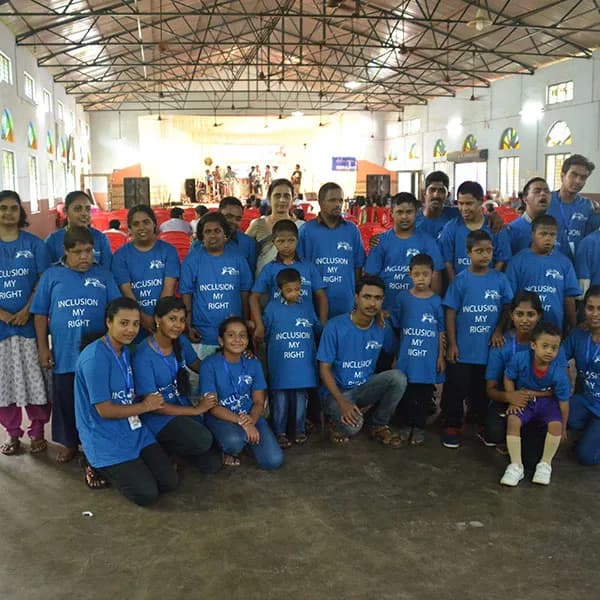 Children in matching blue T-shirts at the celebration