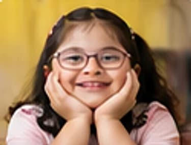 A girl in glasses resting her face in her hands during a learning session