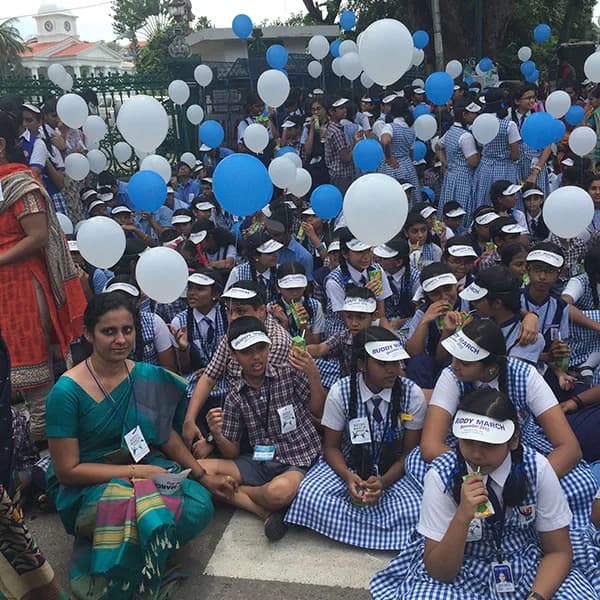 Students with blue and white balloons at the Buddy March for inclusion